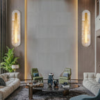 Clérachic Kristy wall lamps either side of a lounge seating area with a marble backdrop.