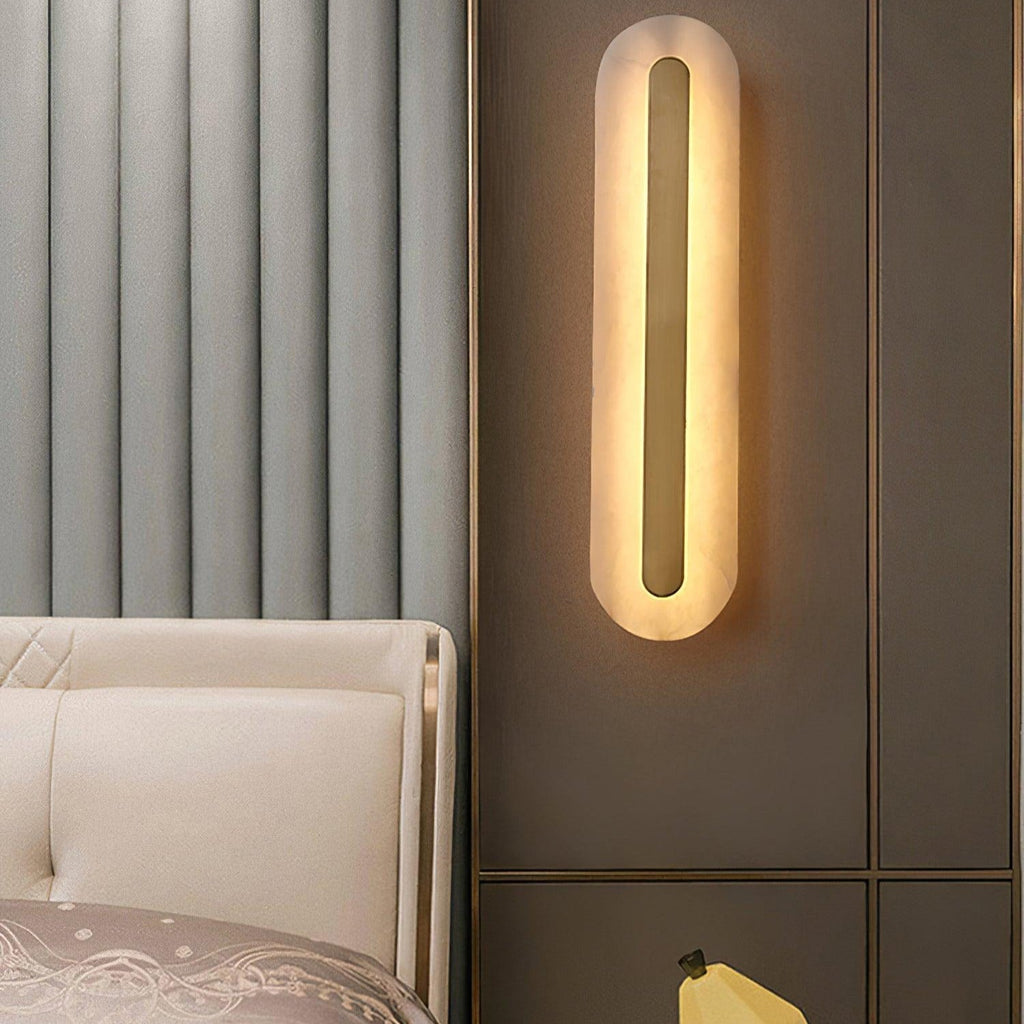 The Clérachic Kristy wall lamp on a ribbed wall beside a cream bed and gold trim.
