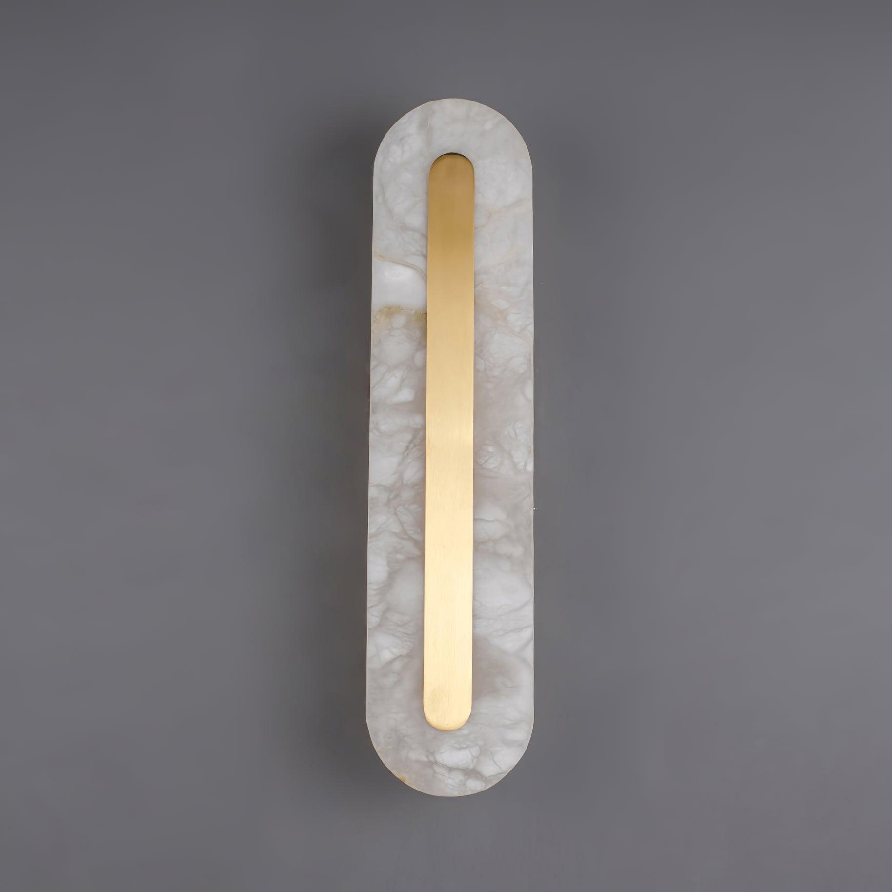 Clérachic Kristy wall lamp lit on grey, warm light pooling above and below the stone.