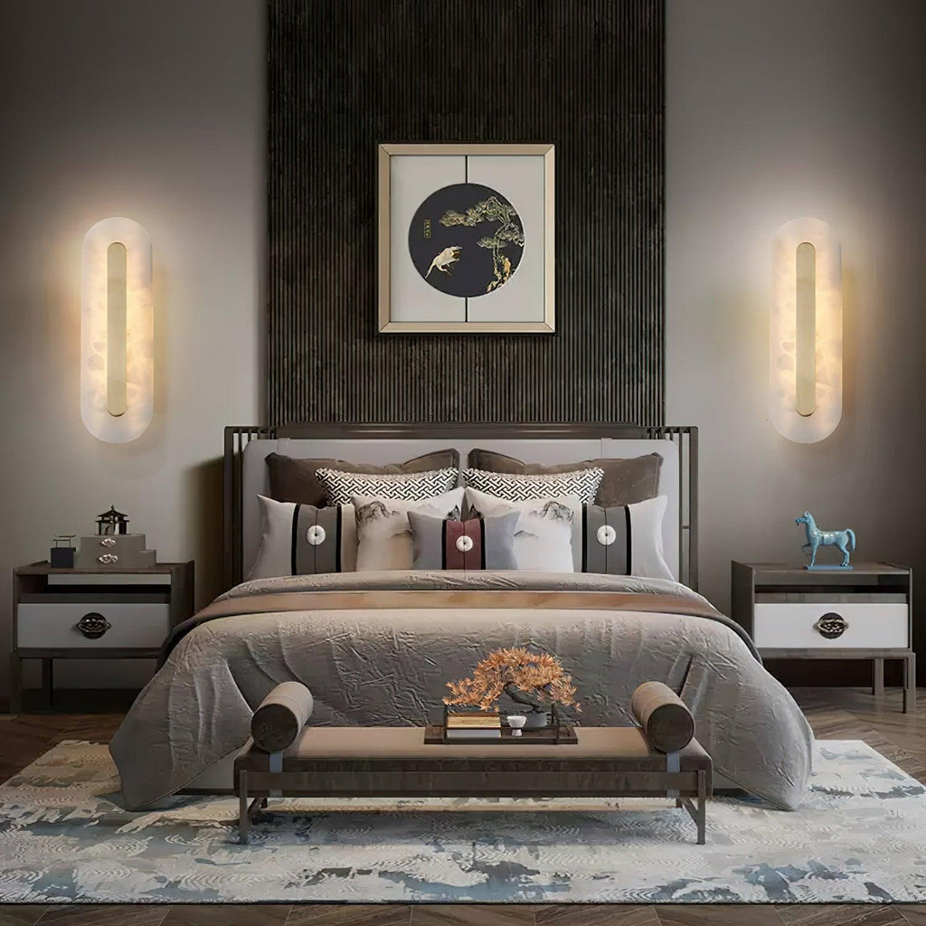 A pair of Clérachic Kristy wall lamps flanking a bed beneath a framed circular artwork.