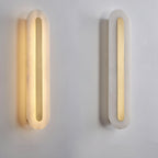 Two Clérachic Kristy wall lamps on plaster, the left lit and the right switched off.
