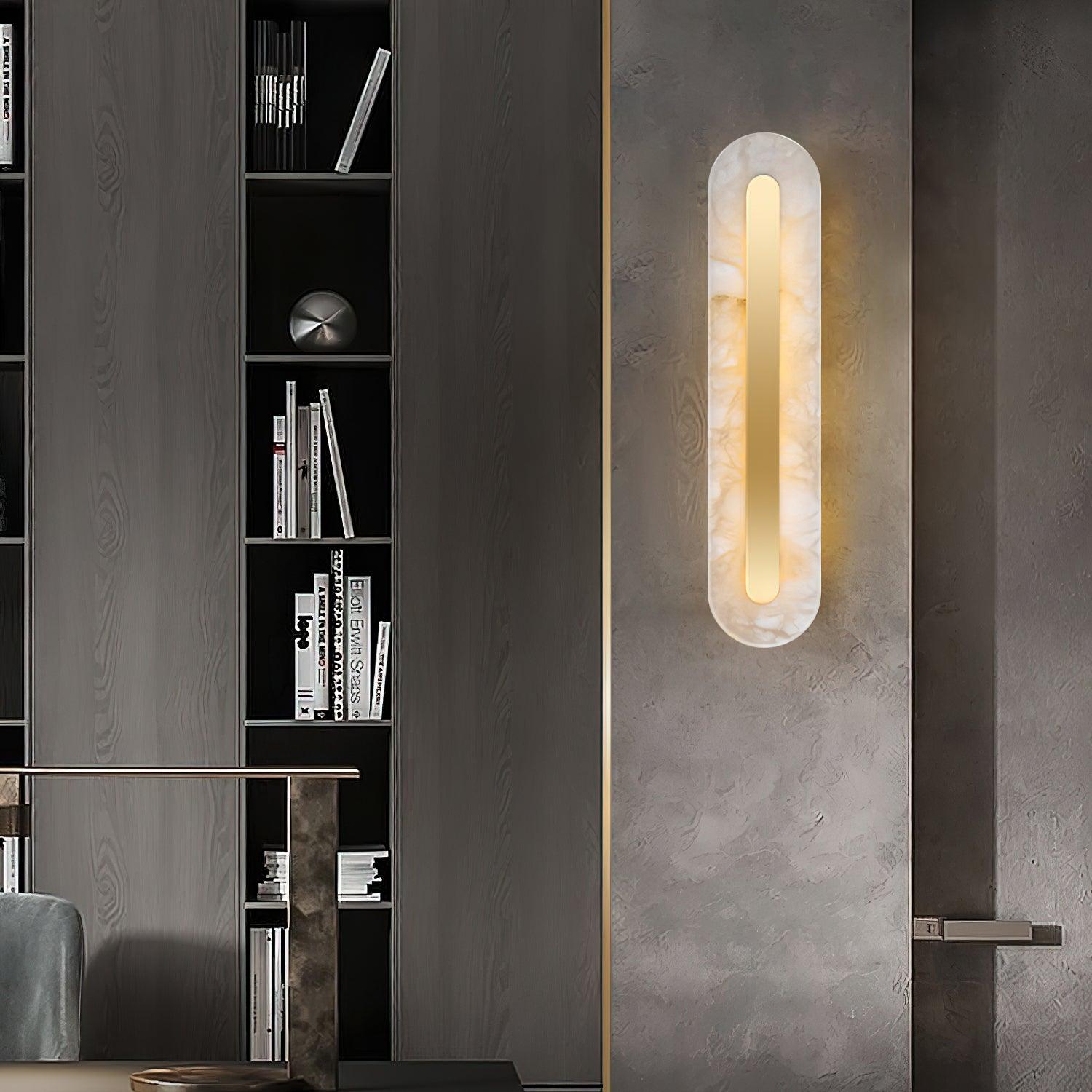 The Clérachic Kristy wall lamp beside a dark bookcase and a concrete-effect door.