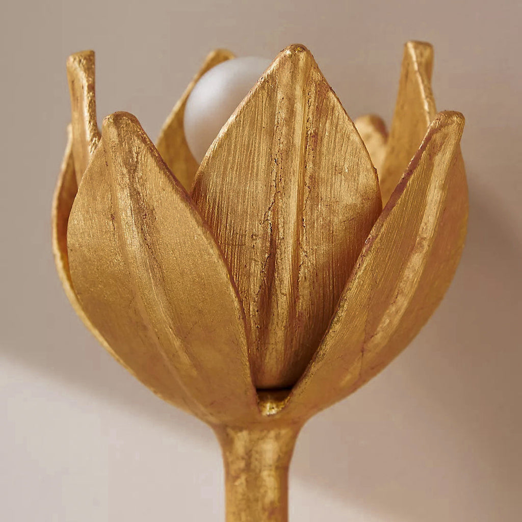 A close-up shows the Clérachic brass tulip head cradling its bulb between sculpted petals.