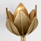 A warm bulb lights the Clérachic brushed brass tulip head from deep within its petals.