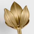 This cropped close-up shows the Clérachic matte gold tulip head and its sculpted petal texture.