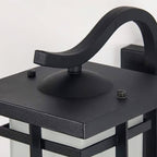 Close view of the curved bracket and square black roof of this Clérachic lantern wall light, with two small screws on top.