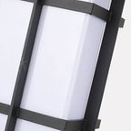 Angled close view of the frosted glass and black grid frame of this Clérachic lantern wall light.