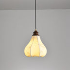 Clérachic fabric pendant light lit warm amber, the line-drawn blossoms showing faintly through the glowing fabric.