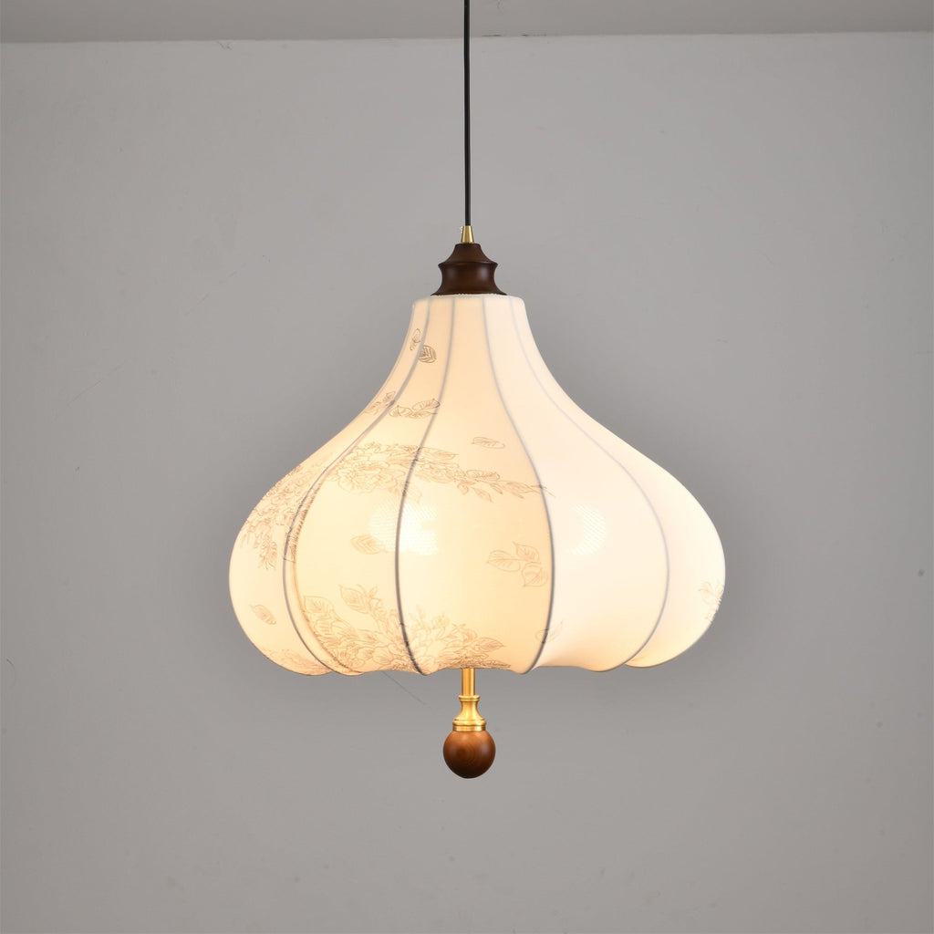 Clérachic fabric pendant light switched on, the two bulbs showing as soft bright patches through the warm fabric.
