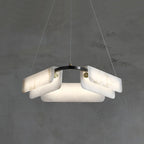 Clérachic Layered Alabaster Plate Chandelier against grey plaster, its overlapped stone plates clipped to a black ring.