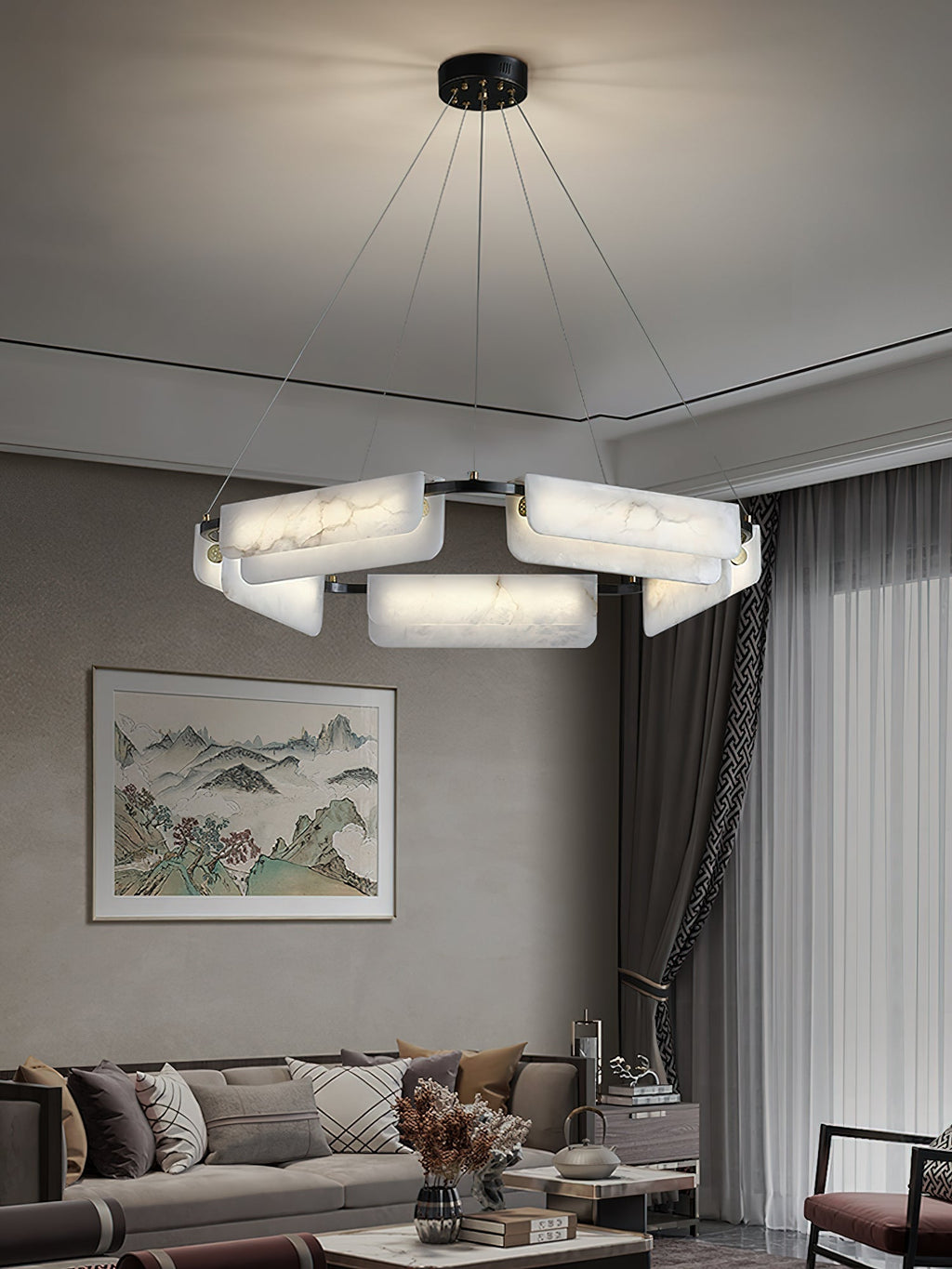 Clérachic Layered Alabaster Plate Chandelier hung from a black ceiling canopy in a lounge with a framed landscape.