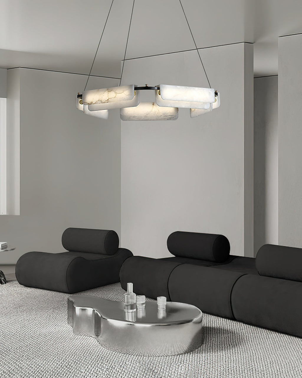 Clérachic Layered Alabaster Plate Chandelier over a black modular sofa and chrome table in a pale minimalist room.