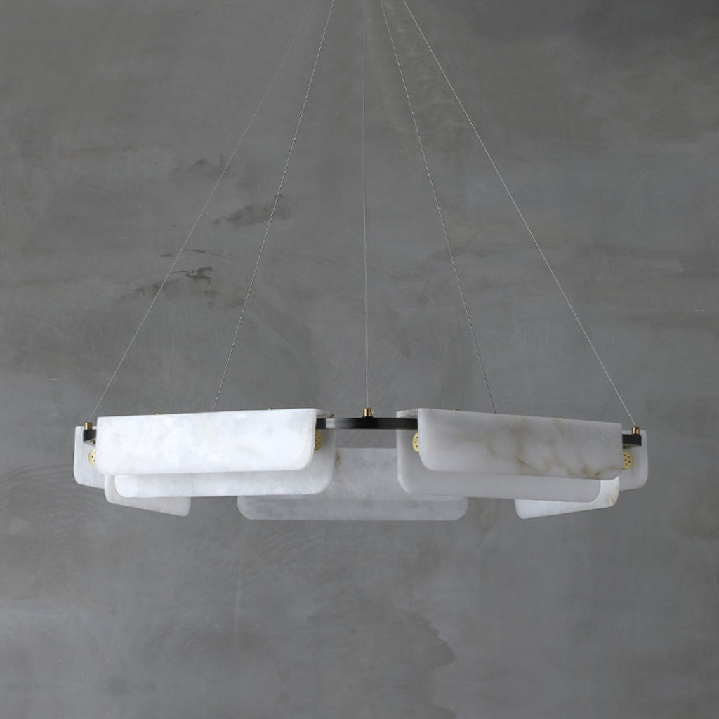 Unlit, the Clérachic Layered Alabaster Plate Chandelier reads chalk-white, its stone plates cool against concrete.
