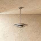 Clérachic pendant light in chrome viewed at an angle, the layered saucer shade reflecting soft ambient light.