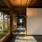 Clérachic pendant light in matte black lighting a stone-walled hallway leading toward an outdoor view.