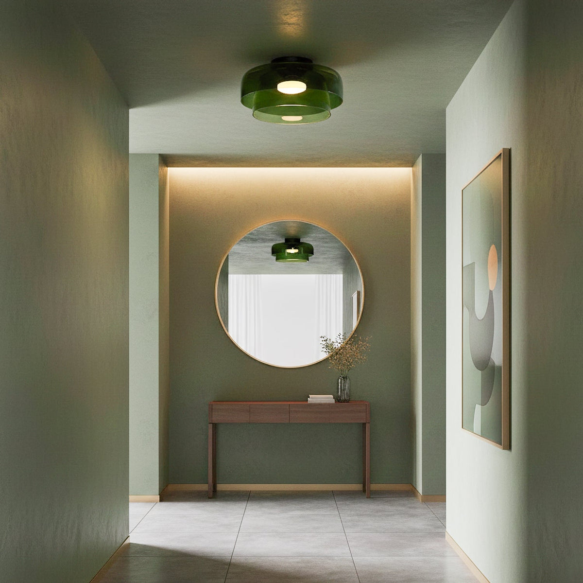A green glass Clérachic ceiling light above a sage-green hallway with a round mirror and a wooden console table.