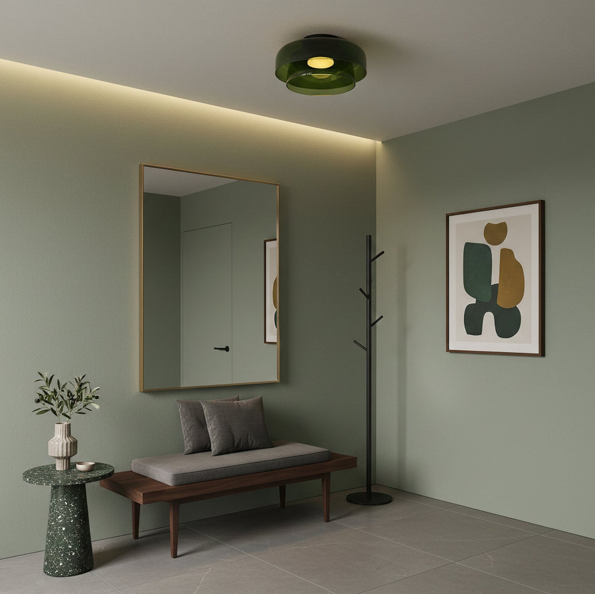 A green glass Clérachic ceiling light in a sage-green entrance with a framed mirror, a bench and a coat stand.