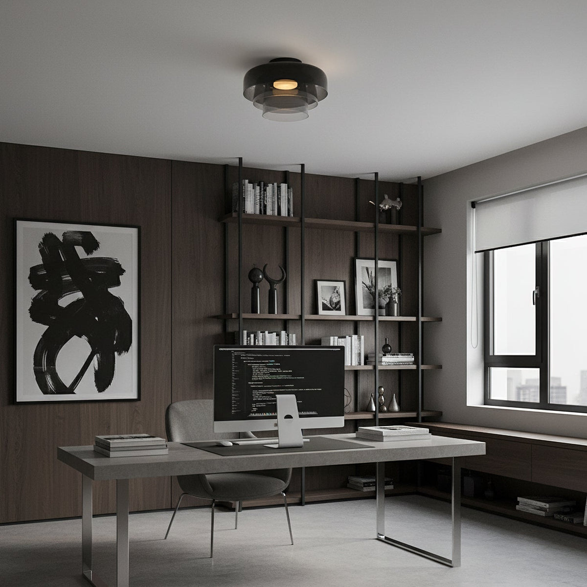 A smoky grey glass Clérachic ceiling light over a home office desk, with dark wood panelling and open shelves behind.