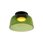 A single-layer green glass Clérachic ceiling light with a deep bowl shape, lit, on a white backdrop.
