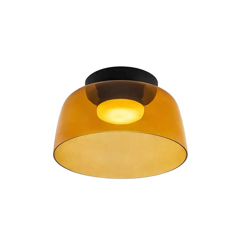 A single-layer orange glass Clérachic ceiling light with a deep bowl shape and a glowing disc, on a white backdrop.