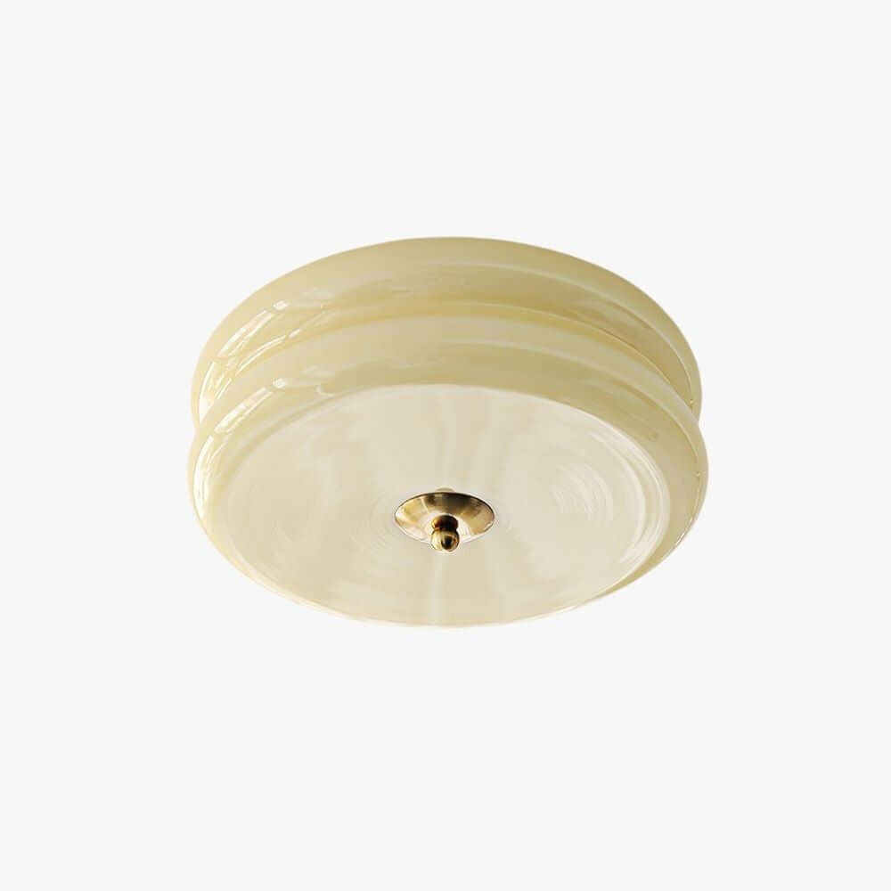 A Clérachic flush mount ceiling light with a layered cream glass shade and a small gold-toned finial, shown on a plain white backdrop.
