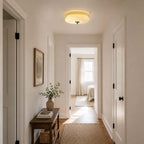 This Clérachic layered glass ceiling light brightens a narrow hallway with white doors, a small console and a woven runner.