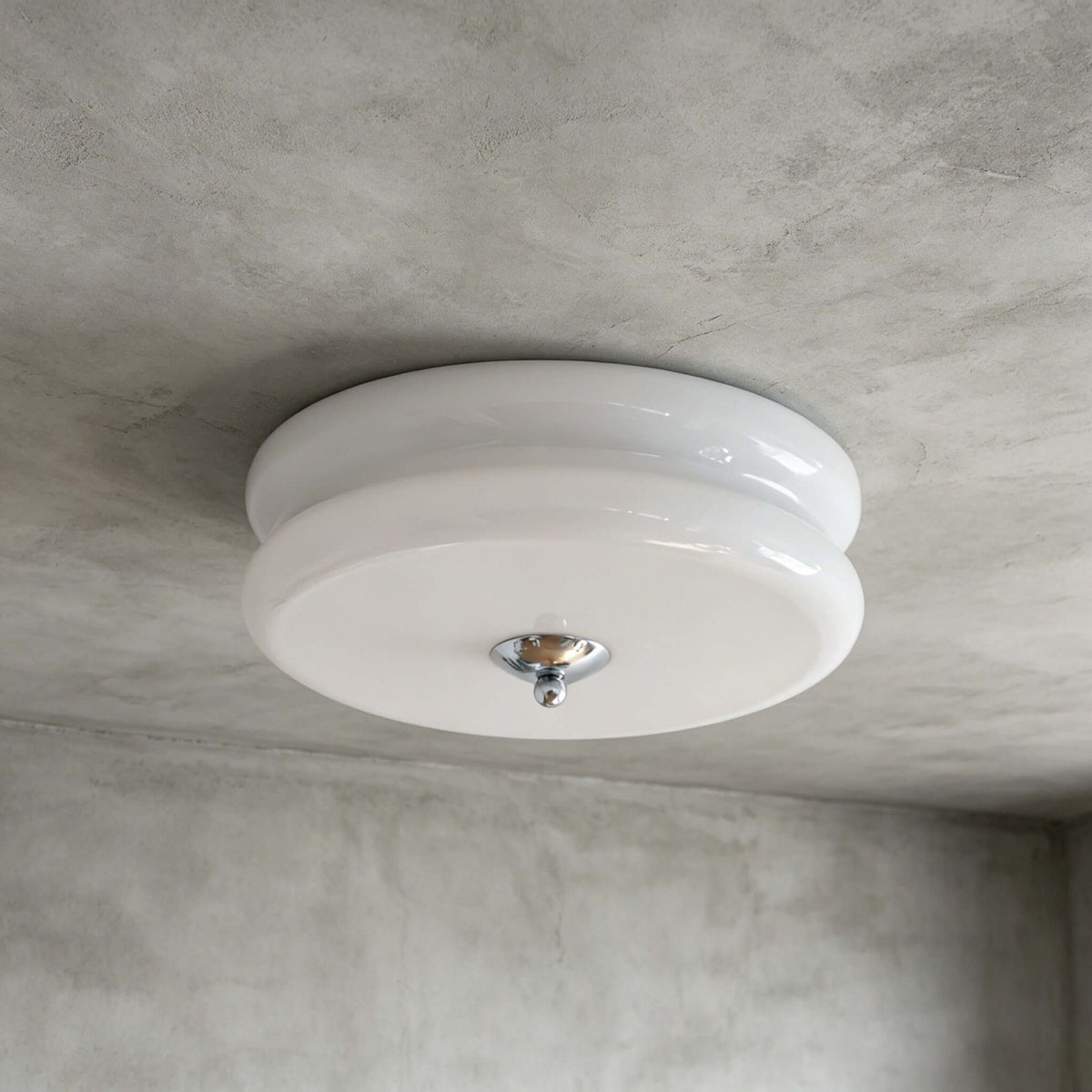 The white and chrome Clérachic flush mount, with a milky layered glass shade and a polished chrome finial, on a grey ceiling.