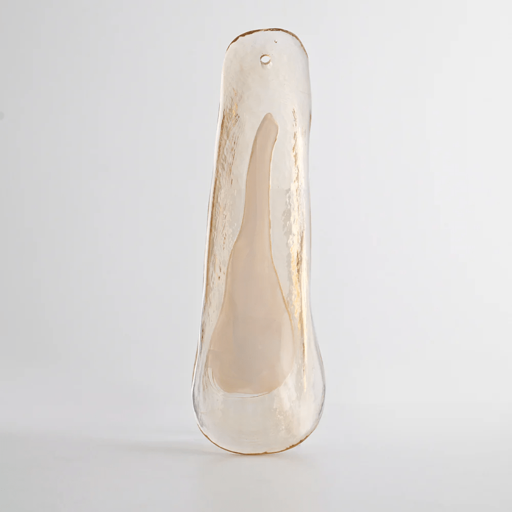 One cloudy beige glass leaf with a fine hole at its top, photographed upright on a pale grey backdrop for a Clérachic chandelier.