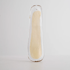 A clear glass leaf with a cream centre and a hanging hole at the top, photographed on grey for this Clérachic chandelier.
