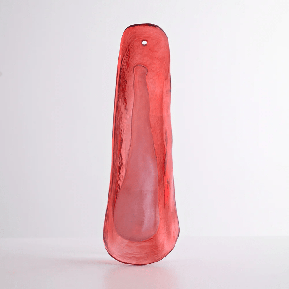 Red glass leaf with a lighter frosted centre, photographed upright for this Clérachic chandelier against a pale backdrop.