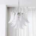 Clear and milky white glass leaves on this Clérachic chandelier, seen against a window with pleated sheer blinds.
