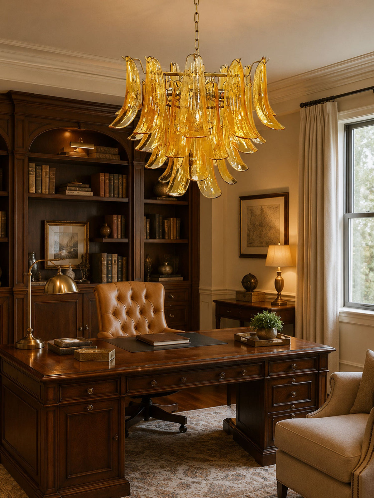 A Clérachic amber glass chandelier lights a wood-panelled study, with a leather chair and a large desk beneath it.