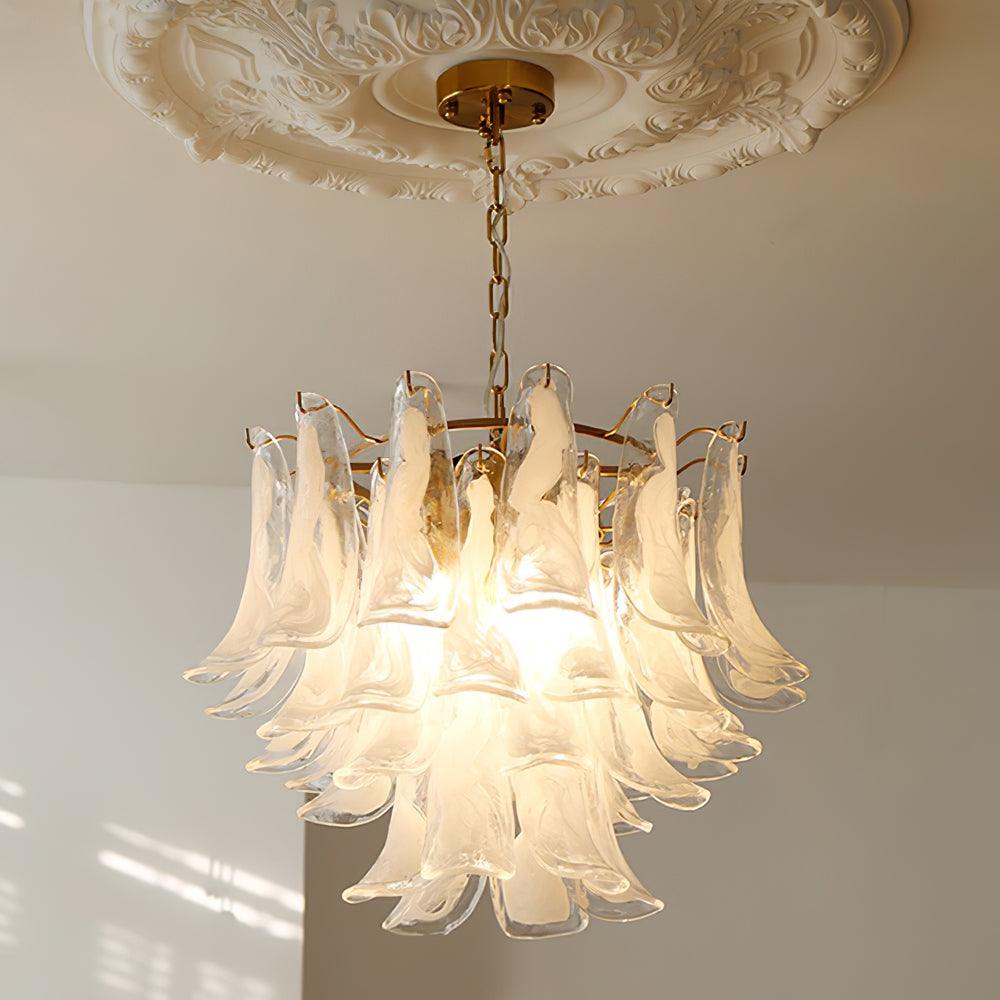 Frosted white cloud glass leaves light up on this Clérachic chandelier, hanging from a brass canopy under a plaster ceiling rose.