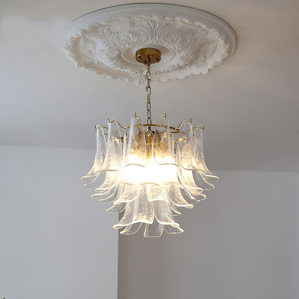 A clear glass leaf chandelier from Clérachic seen from below, unlit, with its brass canopy set against a plaster ceiling rose.
