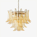 Clérachic glass leaf chandelier in pale amber with gold-edged leaves and a brass ring, shown on a light grey backdrop.