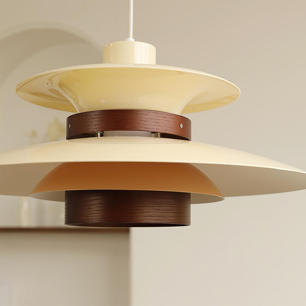 Close view of the beige top shade, dark oak band and wood cylinder of this Clérachic pendant.