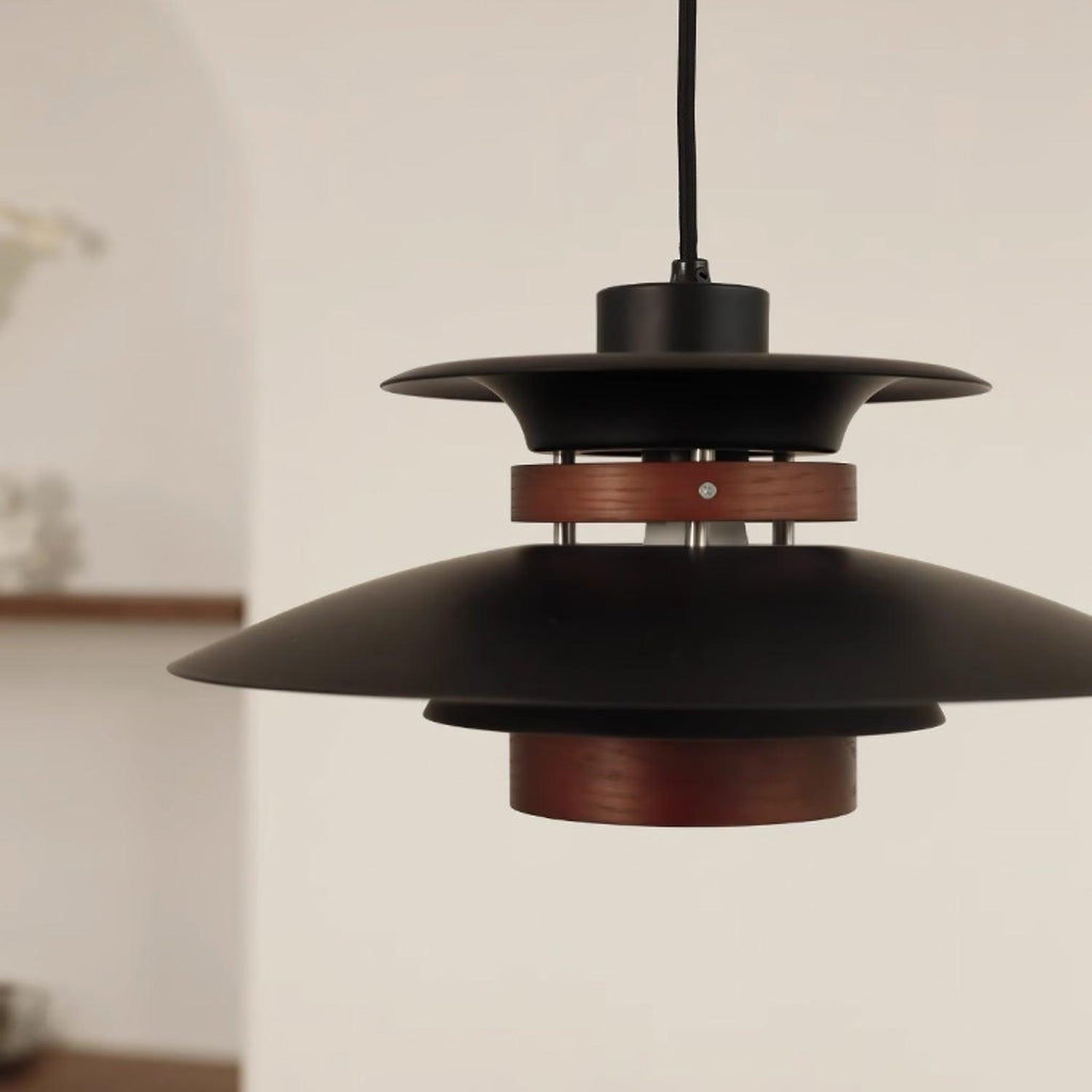 Close view of the black shades, the dark oak band and the wood lower cylinder on this Clérachic pendant.