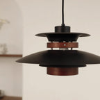 Close view of the black shades, the dark oak band and the wood lower cylinder on this Clérachic pendant.