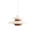 A white Clérachic pendant on a white cord, shown in full on a white backdrop with its dark oak band and cylinder.