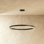 Side angle of the Clérachic single-ring chandelier shows its layered acrylic glow beneath a black metal frame.