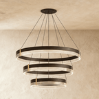 A closer angle of the Clérachic three-tier ring chandelier shows its stepped black bands suspended on fine cables.