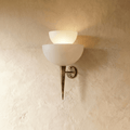 Clérachic wall lamp in vintage brass with two tiered frosted glass shades tapering to a slender pointed base.