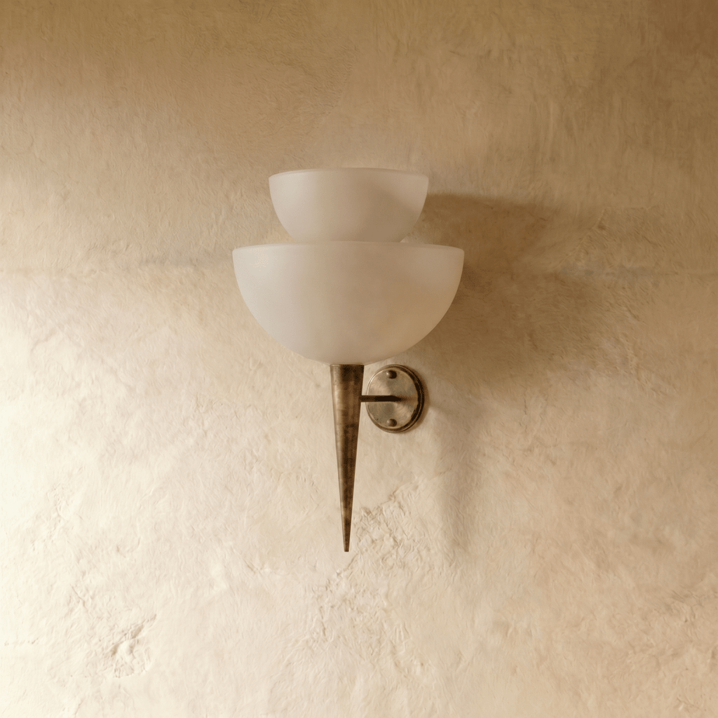 Clérachic wall lamp in vintage brass, front view of the stacked frosted glass shades on a plaster wall.
