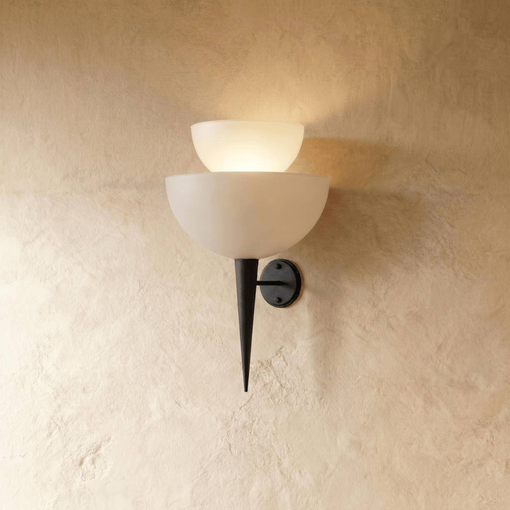 Clérachic wall lamp in matte black, tiered frosted glass shades tapering to a slender pointed base.