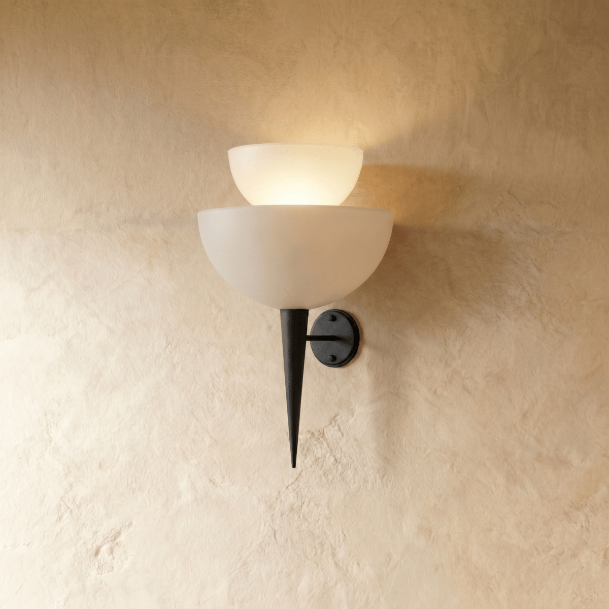 Clérachic wall lamp in matte black, tiered frosted glass shades tapering to a slender pointed base.