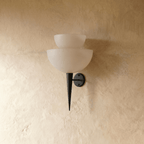 Clérachic wall lamp in matte black, close front view of the stacked frosted glass shades and tip.