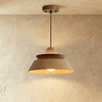 Clérachic tiered wood pendant in oak and dark walnut, glowing warm from the open base, on a round wooden canopy and rod.