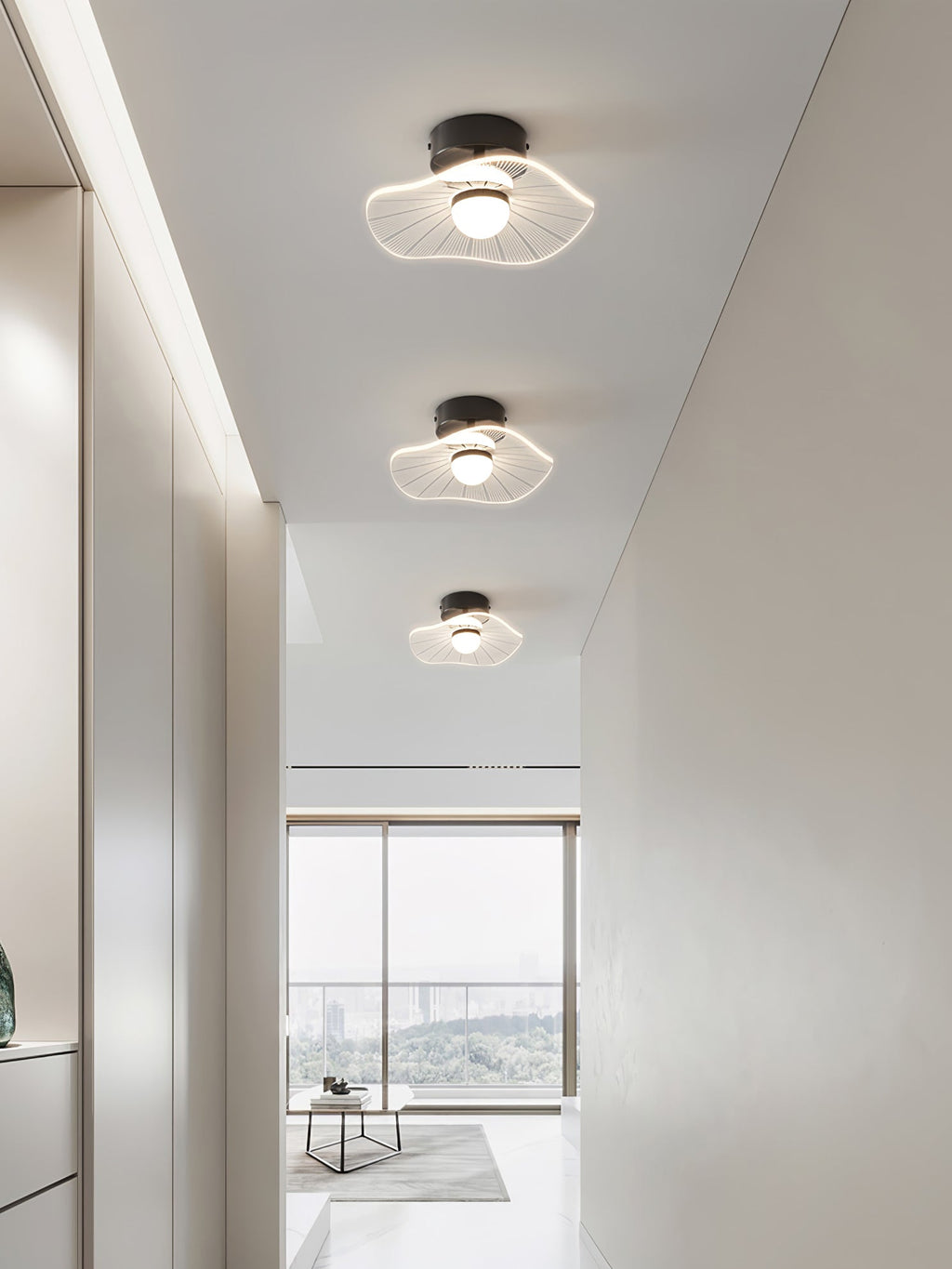 Three wavy acrylic ceiling lights in a row along a white hallway to a bright window, a Clérachic ceiling light.