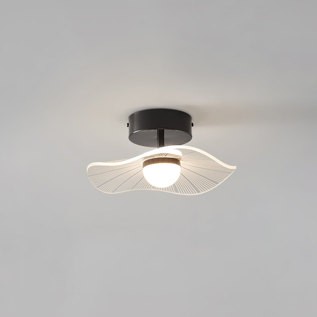 Black-fitted ceiling light with a frilly ribbed acrylic shade and a round opal bulb, on a grey ceiling, from Clérachic.