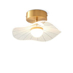 Brass-fitted ceiling light with a leaf-edged clear acrylic shade and a glowing opal globe, on white, a Clérachic ceiling light.
